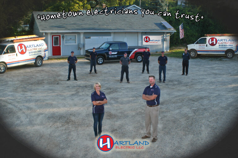 Hartland Electric - a group of people standing in front of their office